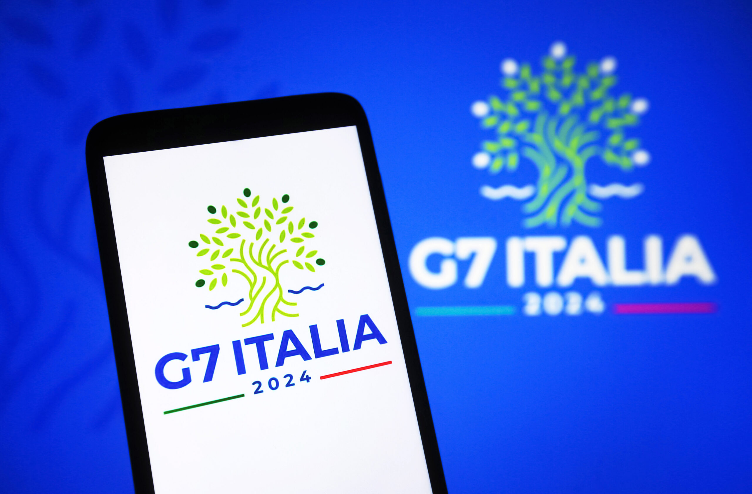 In this photo illustration, the 50th G7 2024 summit logo of the Group of Seven is seen on a smartphone and a pc screen. The 50th G7 summit is scheduled to take place from 13 to 15 June 2024 in Italy. (Photo by Pavlo Gonchar / SOPA Images/Sipa USA)  No Use Germany.